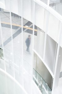 Dance of Light Installation through white expanded metal mesh ceiling